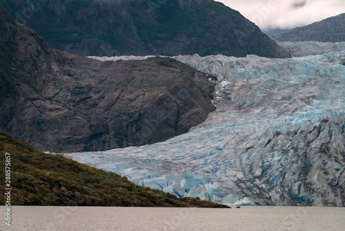 Detailed image Mendenhall Glacier on a rainy day in Juneau, Alaska showing the patterns and blue ice photo