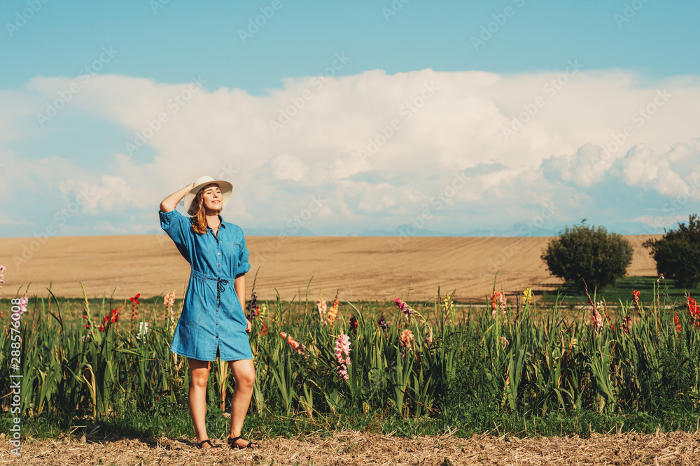 Outdoor portrait of young beautiful girl enjoy nice view in a contryside