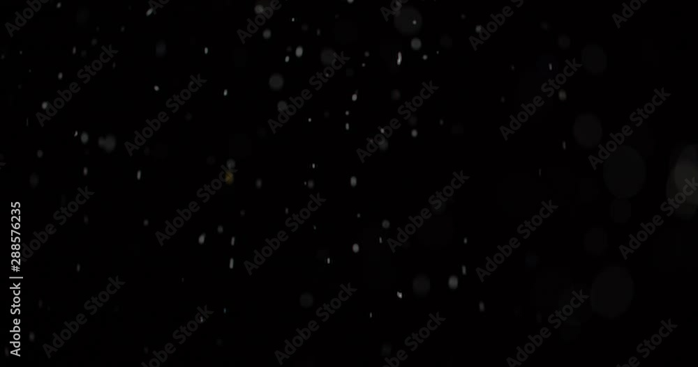 Flying dust particles on a black background