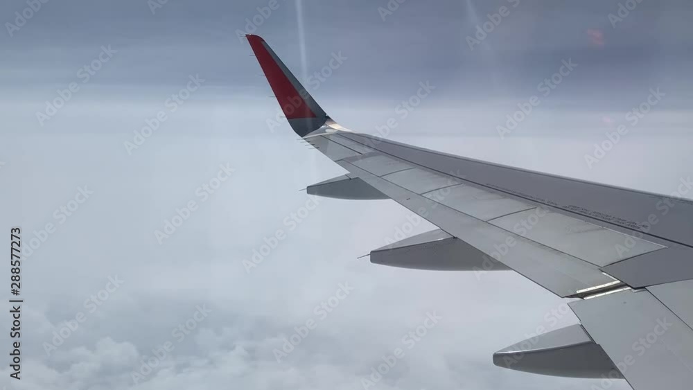 -Airplane flight. Flying above the clouds. View from the window of the plane. Traveling by air -Airplane flight. Flying above the clouds. View from the window of the plane. Traveling by air