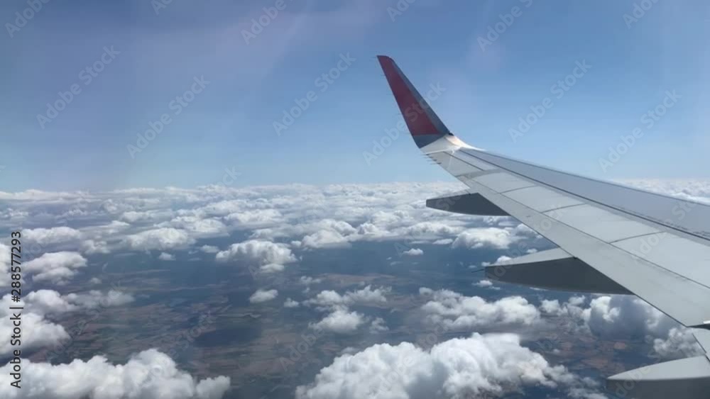 -Airplane flight. Flying above the clouds. View from the window of the plane. Traveling by air