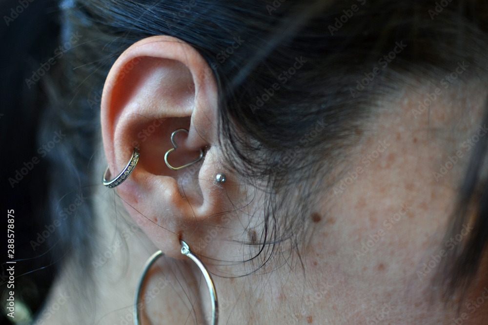woman ear piercing closeup with close in the ear and the hand. Concept of  freedom, liberty, woman, mature, modern Stock Photo | Adobe Stock