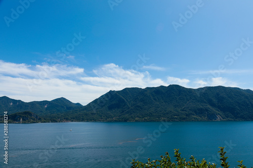 Lago maggiore ore lake maggiore beautiful panorama sunny day with blue sky and fluffy clouds