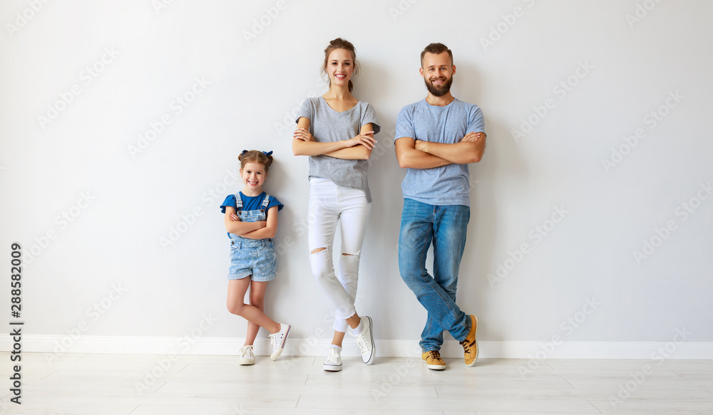 happy family mother father and child near an empty wall happy family mother father and child near an empty wall