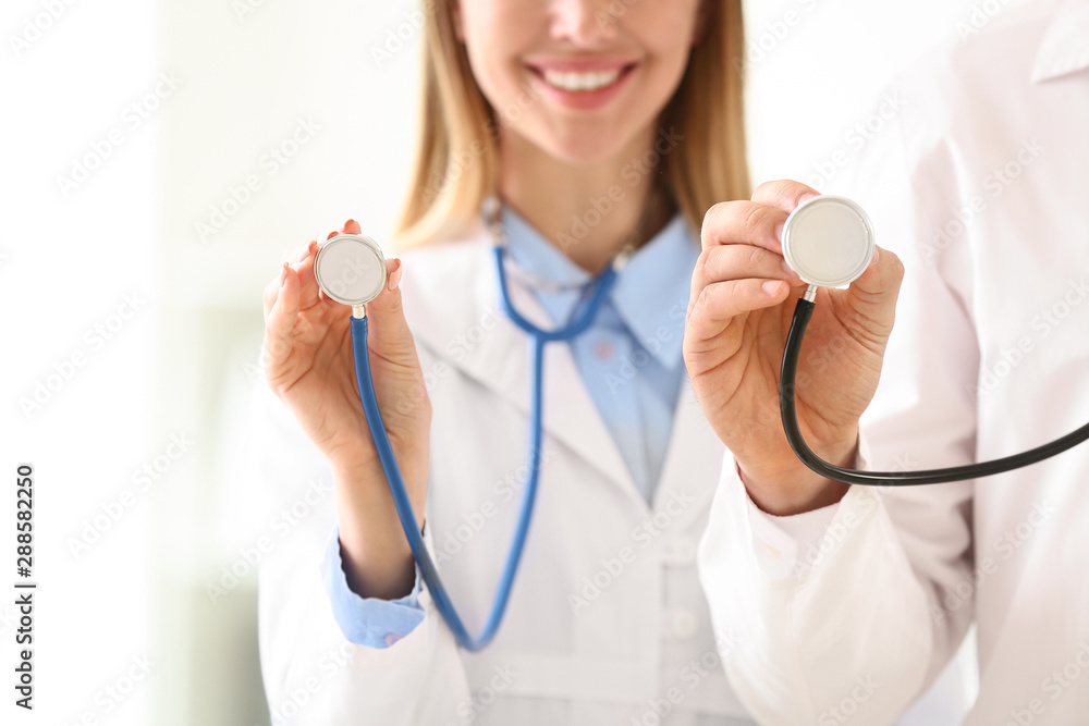Doctors with stethoscopes in clinic Doctors with stethoscopes in clinic