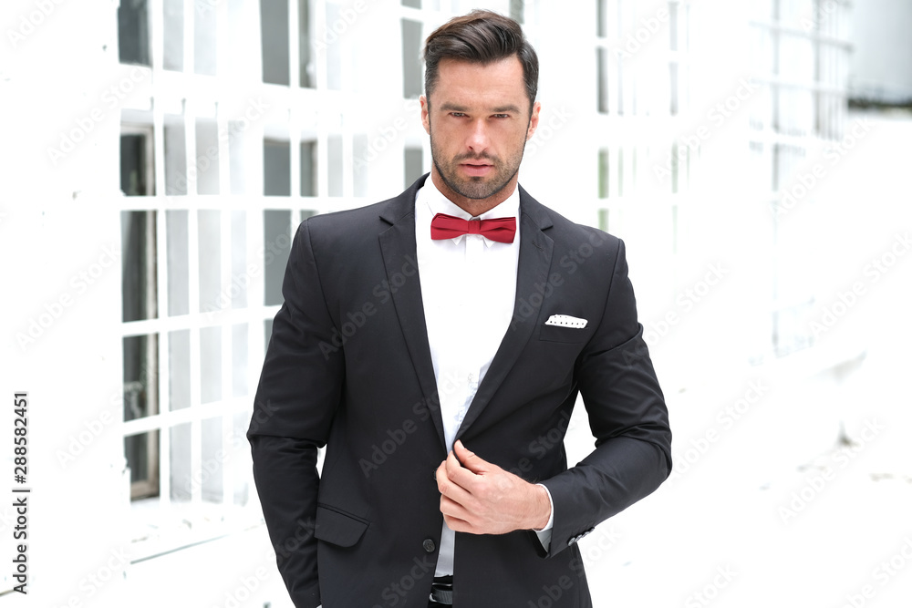 Classy look is always the best. Man wearing a black suit and red bow-tie. Classy look is always the best. Man wearing a black suit and red bow-tie.