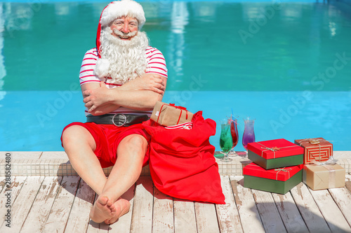 Santa Claus with gifts near...