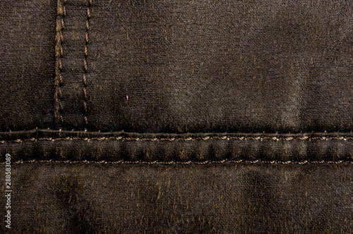 clothing items stonewashed cotton fabric texture with seams, clasps, buttons and rivets, macro