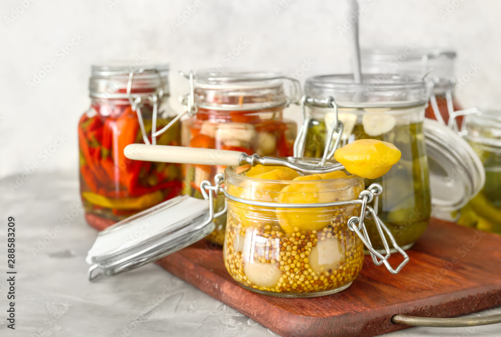 Jars with different canned vegetables on table Jars with different canned vegetables on table