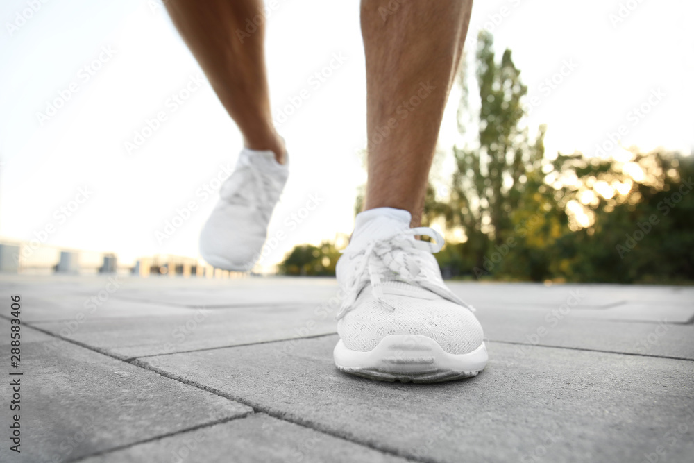 Handsome sporty man running outdoors, closeup Handsome sporty man running outdoors, closeup