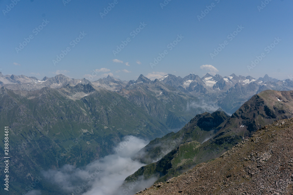 Panorama of the Caucasian ridge and Elbrus viewed from a peak near dombay, 2019