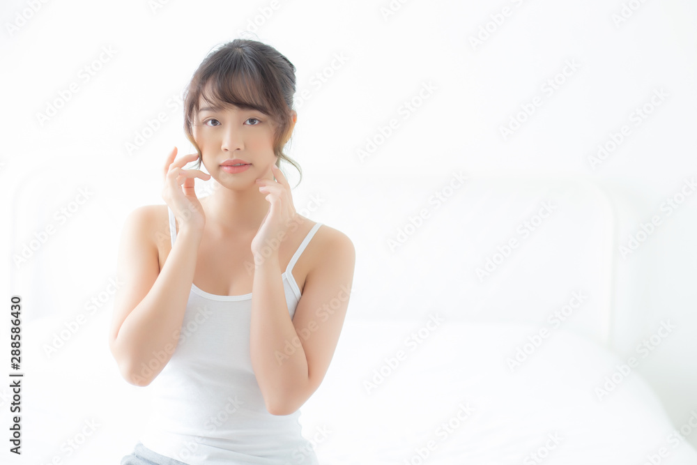 Portrait beautiful asian woman makeup of cosmetic, girl hand touch cheek and smile attractive, face beauty perfect with wellness in the bedroom at home with skin care and healthcare concept. Portrait beautiful asian woman makeup of cosmetic, girl hand touch cheek and smile attractive, face beauty perfect with wellness in the bedroom at home with skin care and healthcare concept.