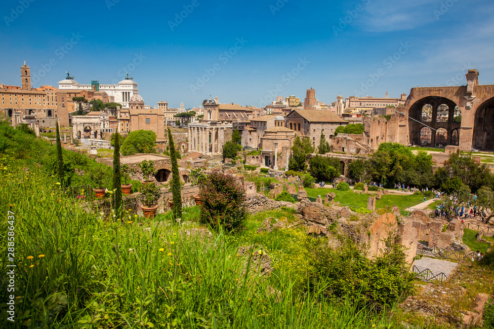 Tourists visiting the Roman Forum in a beautiful early spring day in Rome