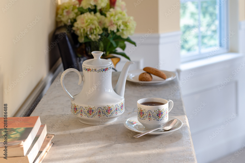 Antique White Porcelain Tea and Coffee Pot with Cup with Stacked Books