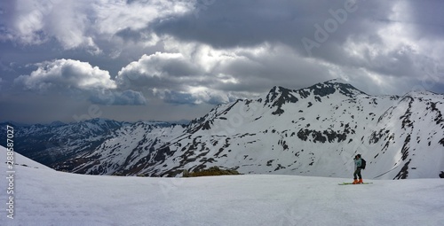 ski mountaineer taking pictures of mountain scenery while ascending Mt. Sonnblick at Hohe Tauern national park, Austria photo