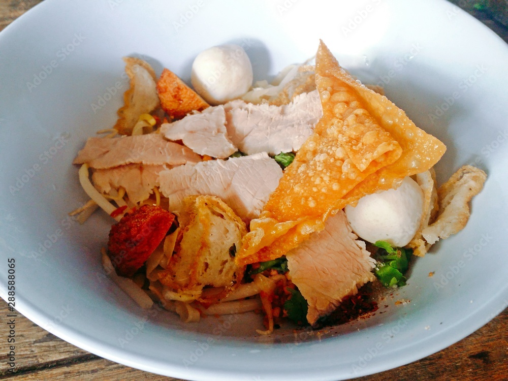 Thai spicy dried rice noodles with pork, fish balls, shrimp balls and crispy wonton. Thai spicy dried rice noodles with pork, fish balls, shrimp balls and crispy wonton.