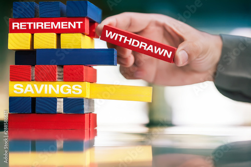 An small business owner's hand; withdrawing money from retirement plan an savings account.