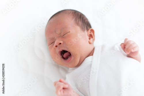 Baby crying on a crib
