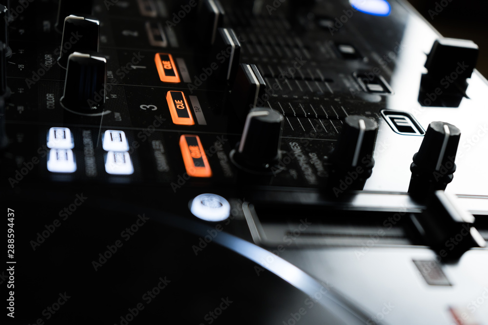 Wide angle photo of black sound mixer controller with knobs and sliders Wide angle photo of black sound mixer controller with knobs and sliders