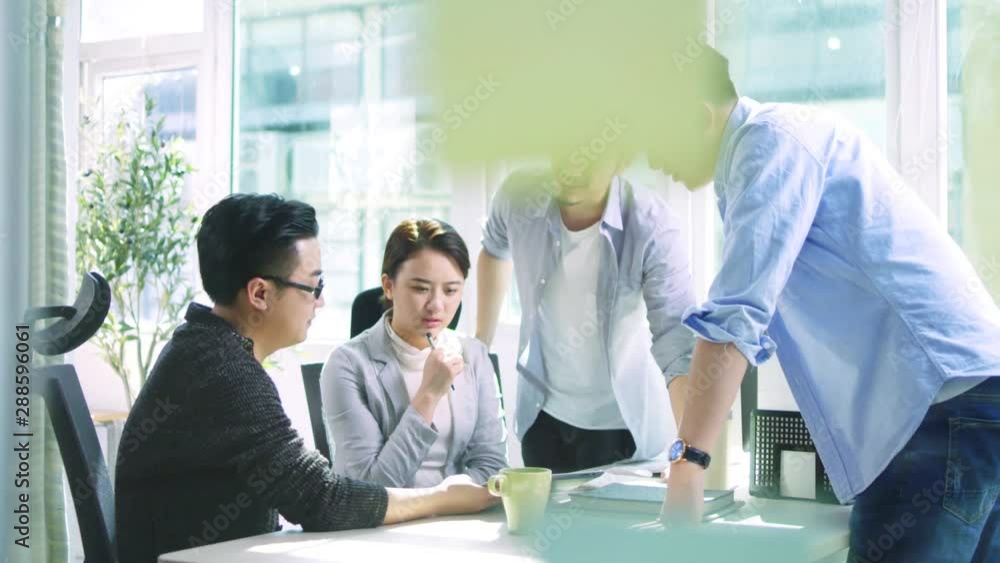 group of young asian business people men and woman meeting discussing in office