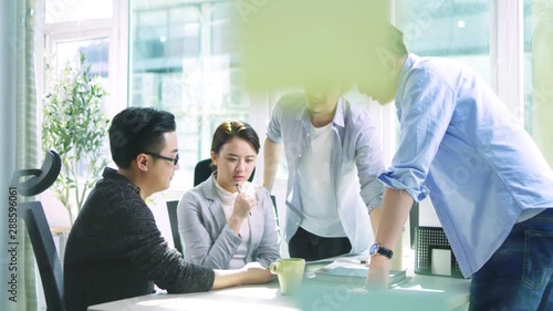 group of young asian business people men and woman meeting discussing in office