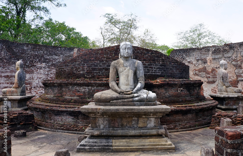 Seated Buddhas in the ruins of a relic house at the Ancient City of Polonnaruwa, Sri Lanka Seated Buddhas in the ruins of a relic house at the Ancient City of Polonnaruwa, Sri Lanka