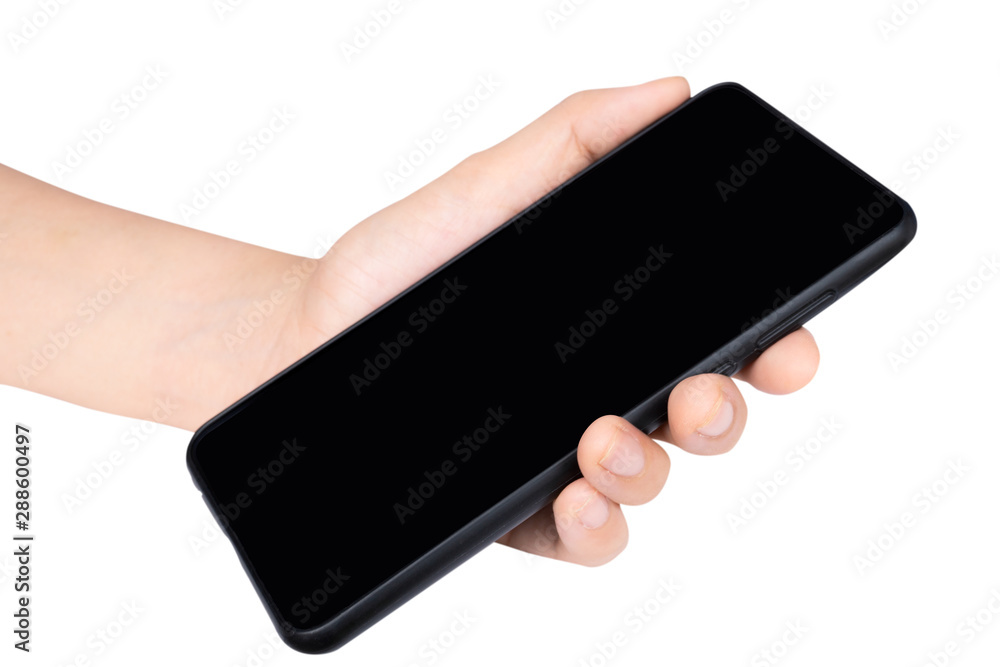 Close up adult woman hand holding and touching screen on the modern black smartphone mock up in vertical position with blank screen isolated on white background with clipping path. Close up adult woman hand holding and touching screen on the modern black smartphone mock up in vertical position with blank screen isolated on white background with clipping path.
