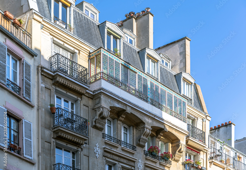 Residential high-rise building with balconies and flower pots