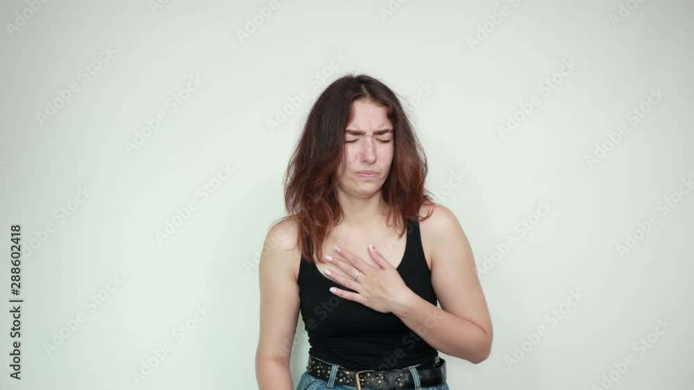 beautiful girl in black tank top over isolated white background shows emotions beautiful girl in black tank top over isolated white background shows emotions