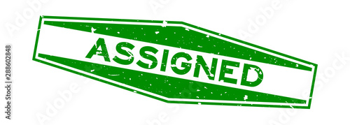 Grunge green assigned word hexagon rubber seal stamp on white background