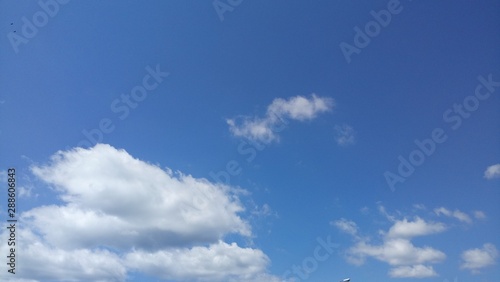 Fluffy White Clouds With Blue Sky Background