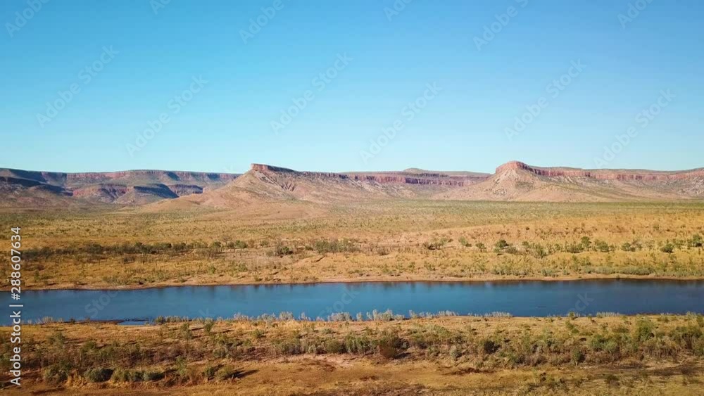 Pedestal aerial shot of arid mountain range and river. Pedestal aerial shot of arid mountain range and river.