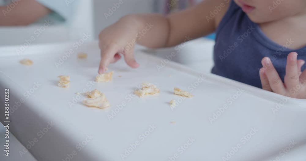Baby try to pick the food up by herself and successful Baby try to pick the food up by herself and successful