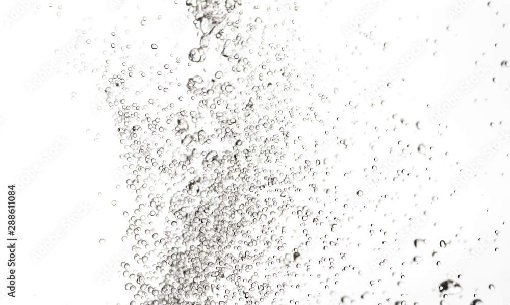 splashes, jets and drops of water hovering in the air on a white background