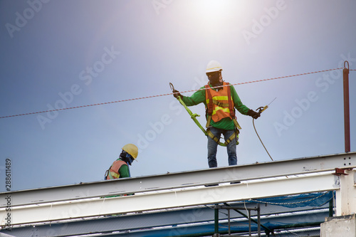 Wallpaper Mural Man working on construction site with scaffold and building with sky background,scaffolding for construction factory Torontodigital.ca