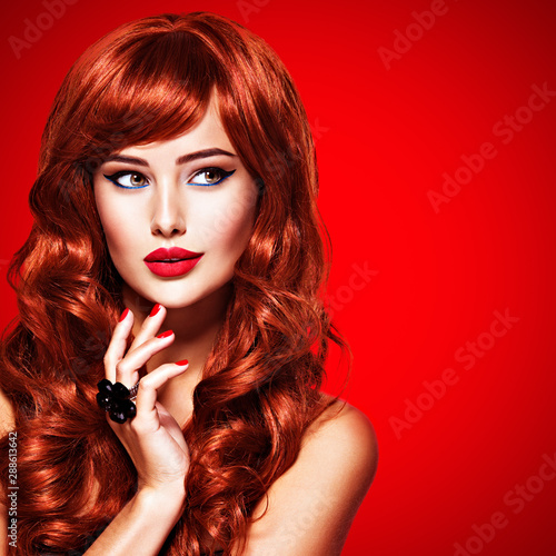 Beautiful sensual woman with long red hair.