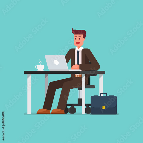 Business man working on a laptop computer at office desk