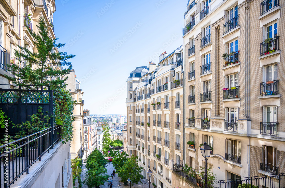 View of Paris through the houses on a hill on Montmartre