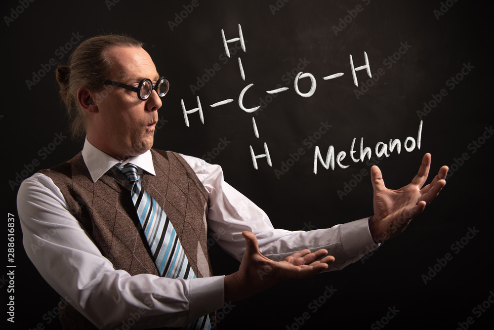 Professor presenting handdrawn chemical formula of Methanol Professor presenting handdrawn chemical formula of Methanol
