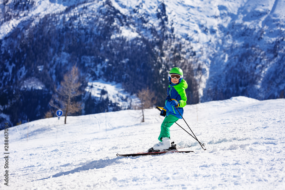 Little skier having fun riding down the slope Little skier having fun riding down the slope