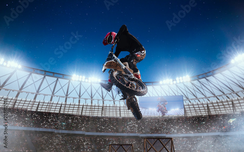 Motofreestyle on professional stadium in night. Fmx. Motocross. photo