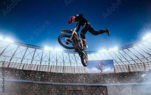 Motofreestyle on professional stadium in night. Fmx. Motocross. photo