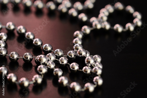 Silver Christmas decoration on a dark wooden background close up