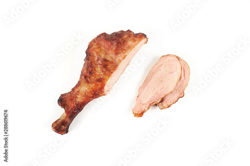 roast turkey leg and sliced turkey meat isolated on white background.