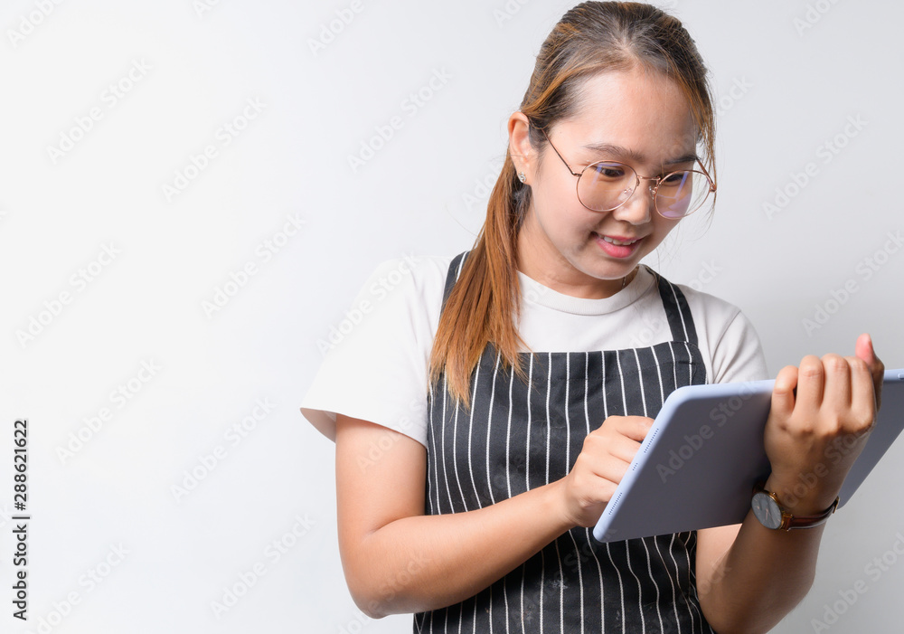 Young Asian woman The restaurant owner concept on white background using tablet for business concept, business concept with copy space Young Asian woman The restaurant owner concept on white background using tablet for business concept, business concept with copy space