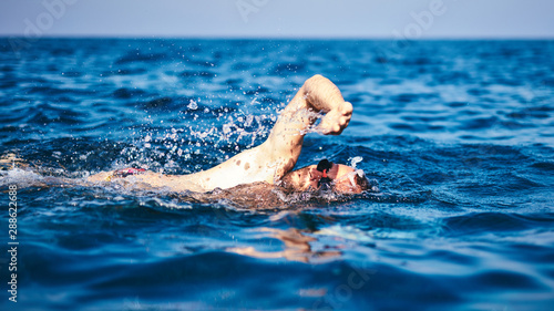 Swimmer training on the open sea / ocean. © astrosystem