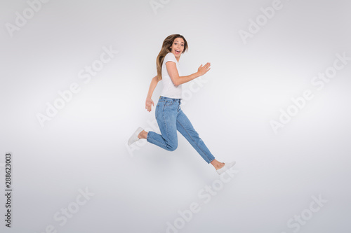 Full length body size photo of girlfriend running forward looking into camera while isolated with white background