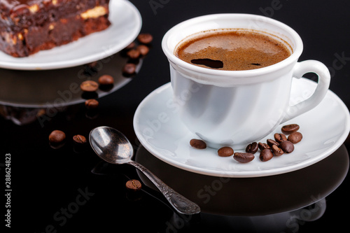 Fototapeta Naklejka Na Ścianę i Meble -  Cup of coffee on a black glass table