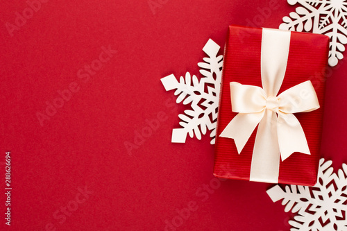 Christmas, holiday present box on red background.