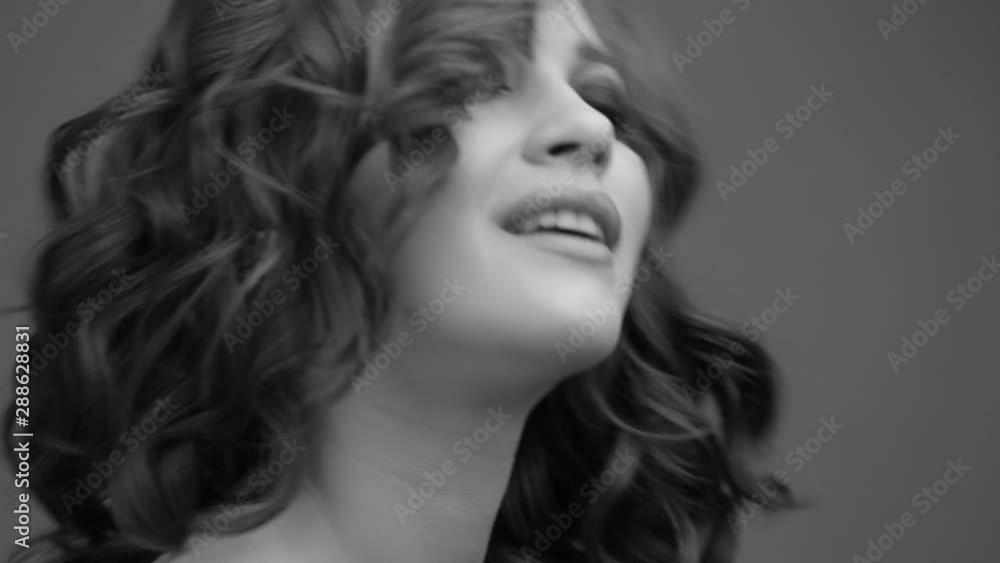 Brunette posing on camera. Black and white video. Emotions girls with a slight flirtation. Chewing gum. Brunette posing on camera. Black and white video. Emotions girls with a slight flirtation. Chewing gum.
